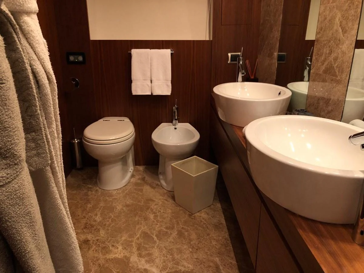 a bathroom with a sink toilet and bathtub aboard GINEVRA Yacht for Charter