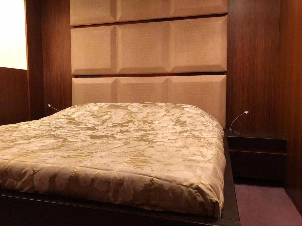a bed with a white sheet aboard GINEVRA Yacht for Charter