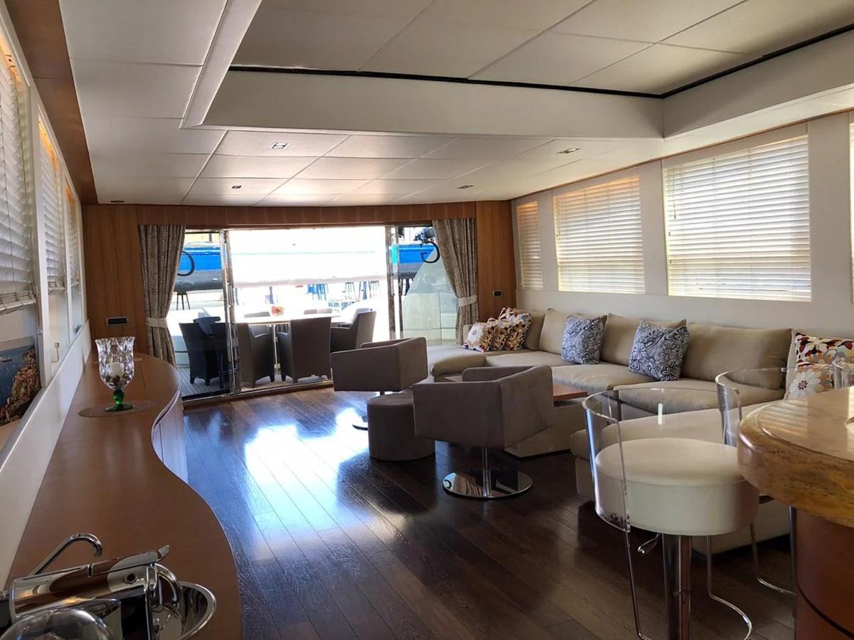a living room with a large window aboard GINEVRA Yacht for Charter
