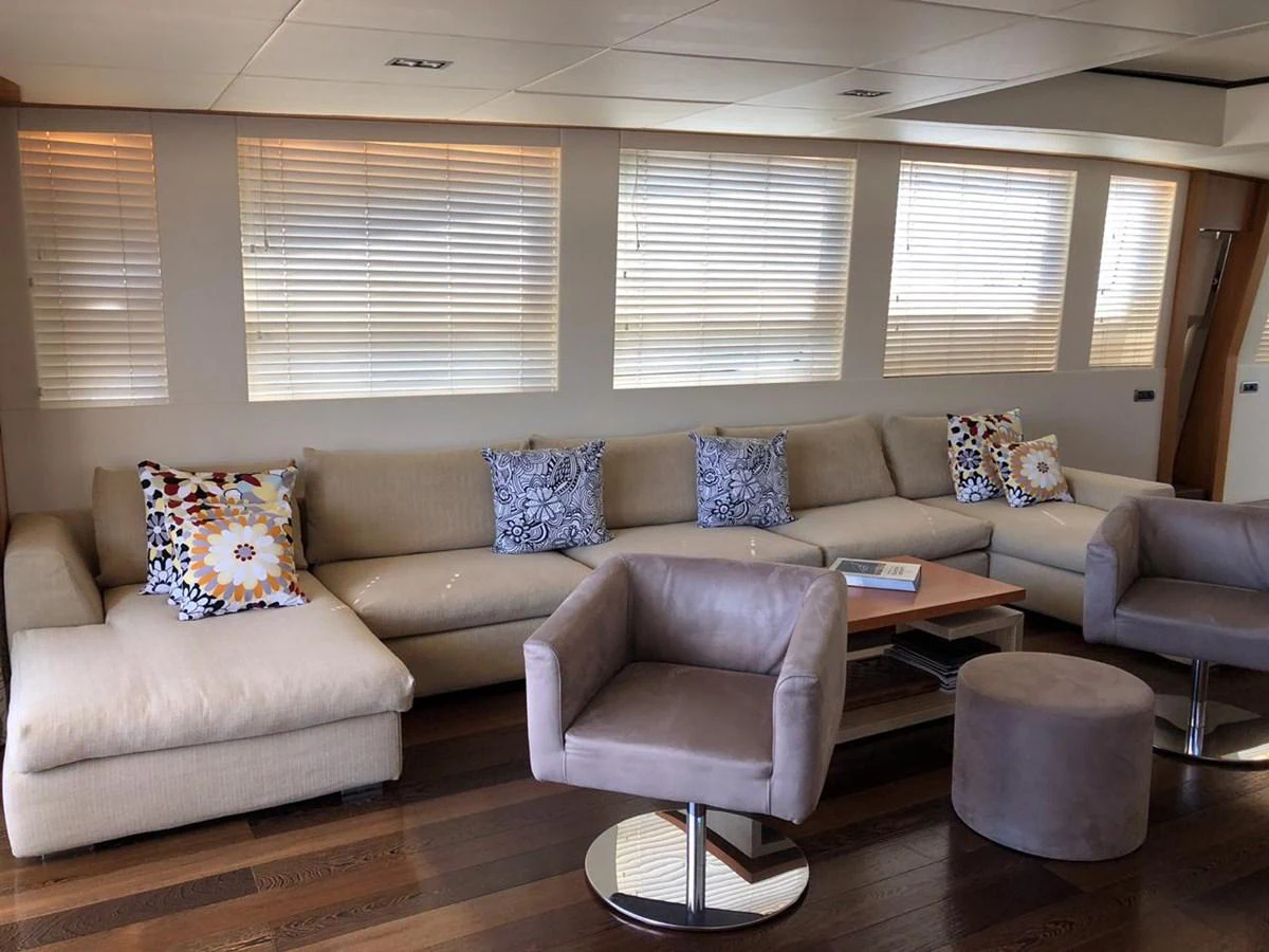 a living room with a couch and a table aboard GINEVRA Yacht for Charter