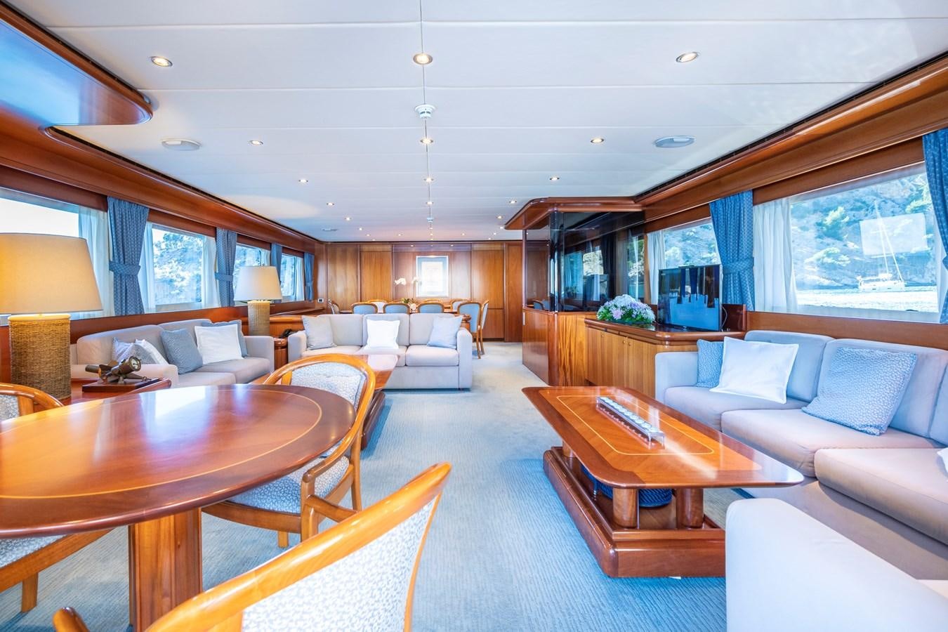 a living room with a table and couches aboard ALCOR Yacht for Charter
