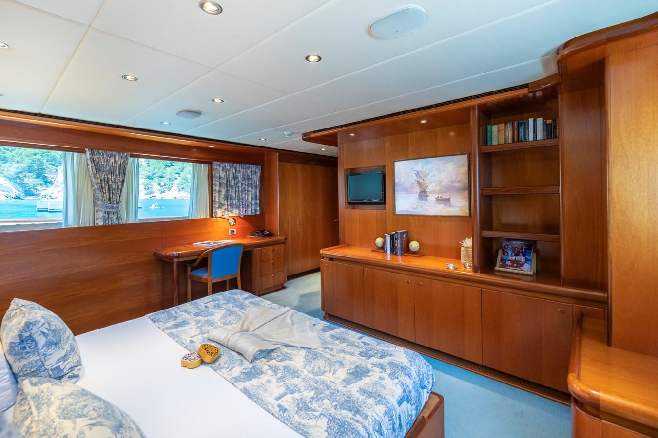 a bedroom with a bed and a desk aboard ALCOR Yacht for Charter