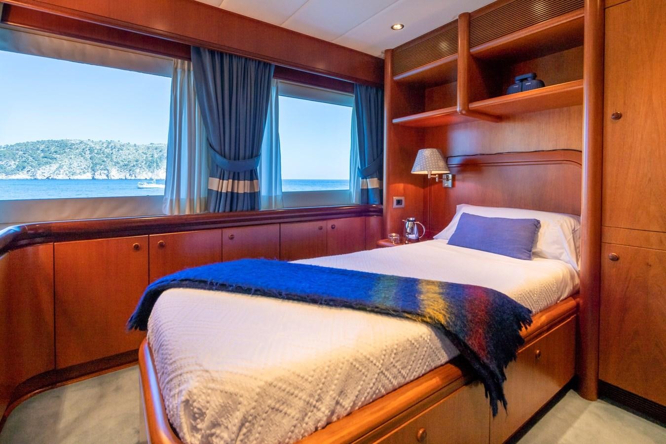 a bedroom with a bed and a window aboard ALCOR Yacht for Charter