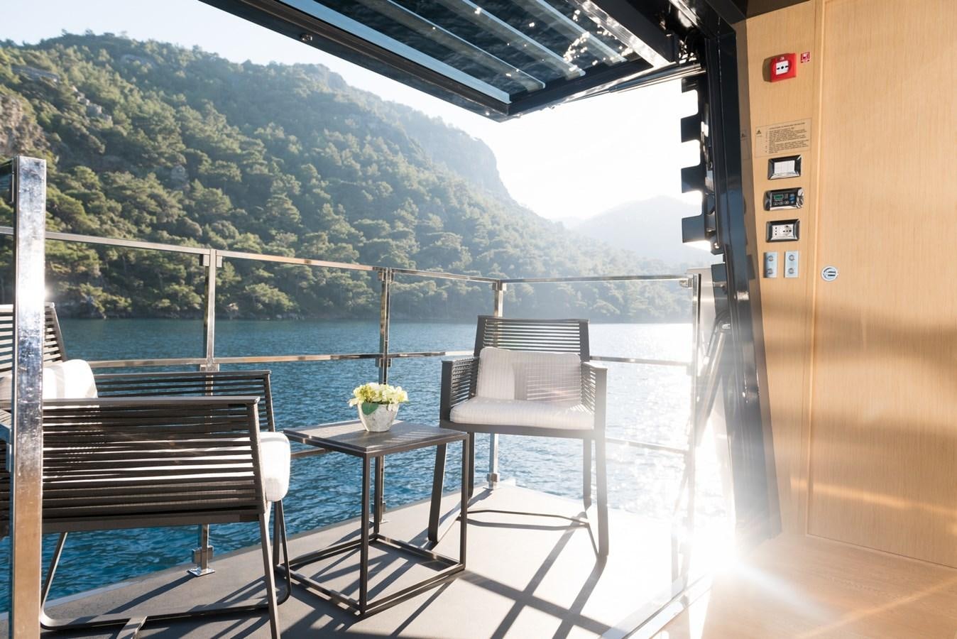 a table and chairs on a balcony aboard SUN Yacht for Sale
