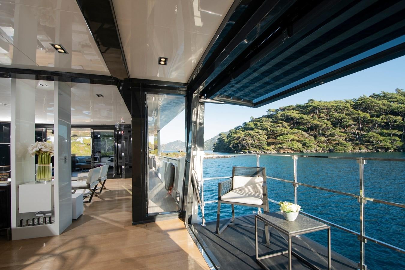 a room with a table and chairs and a pool aboard SUN Yacht for Sale
