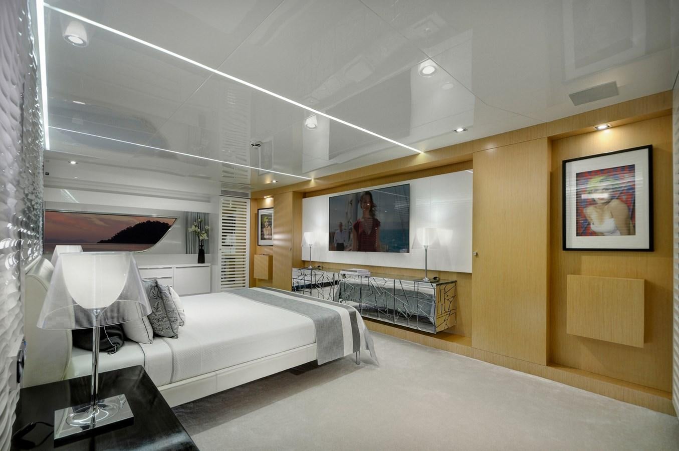 a room with a bed and a tv on the wall aboard SUN Yacht for Sale