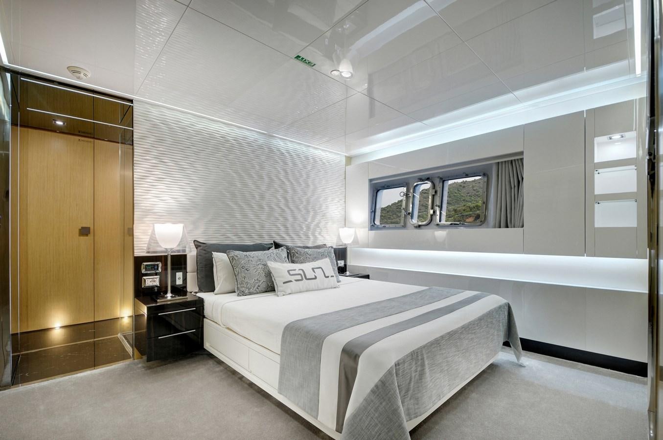 a bedroom with a bed and a window aboard SUN Yacht for Sale