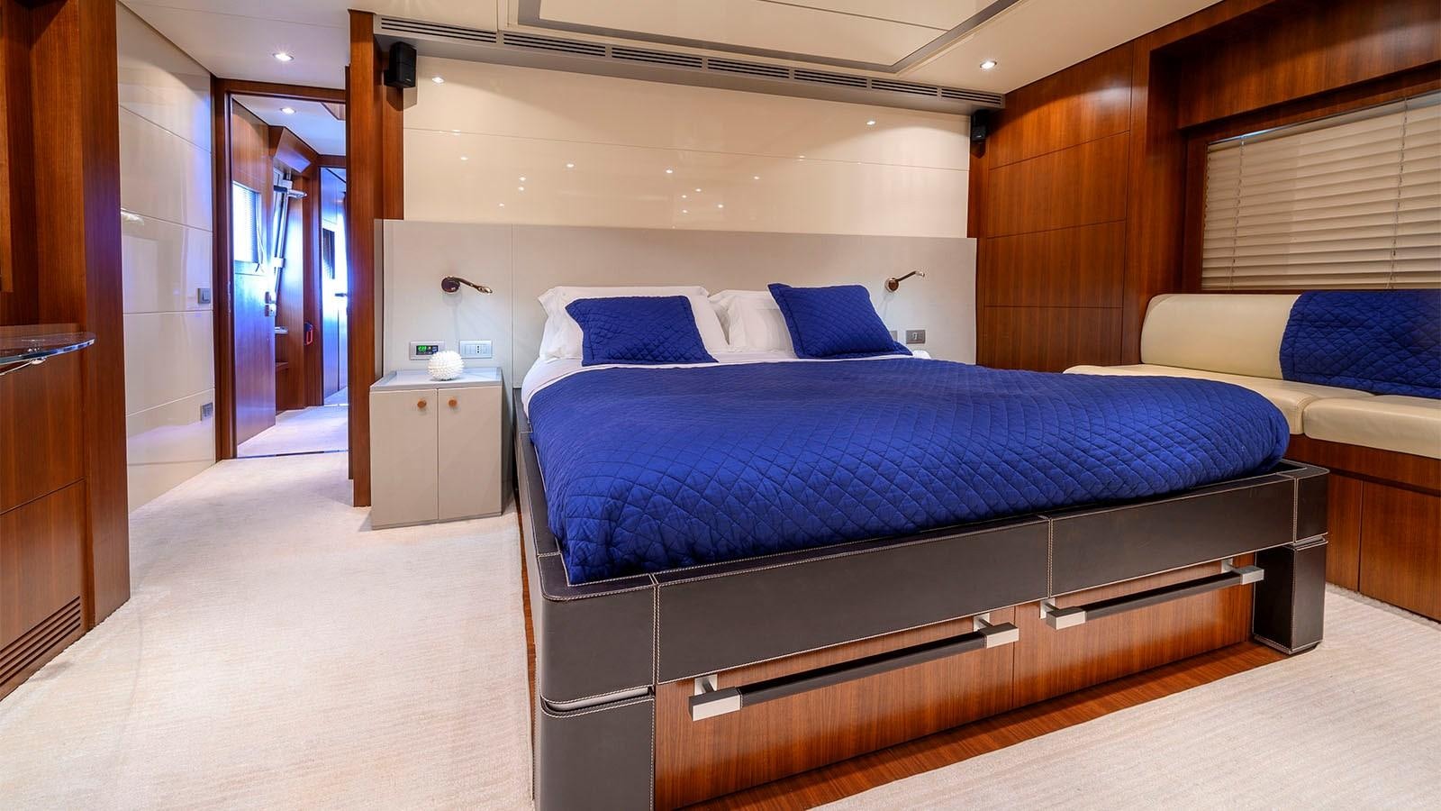 a room with a bed and a desk aboard BEYOND Yacht for Sale