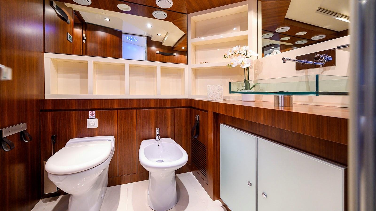 a bathroom with a toilet and a sink aboard BEYOND Yacht for Sale
