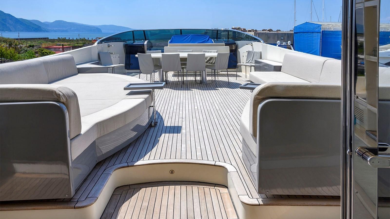 a balcony with a view of the ocean and the mountains aboard BEYOND Yacht for Sale