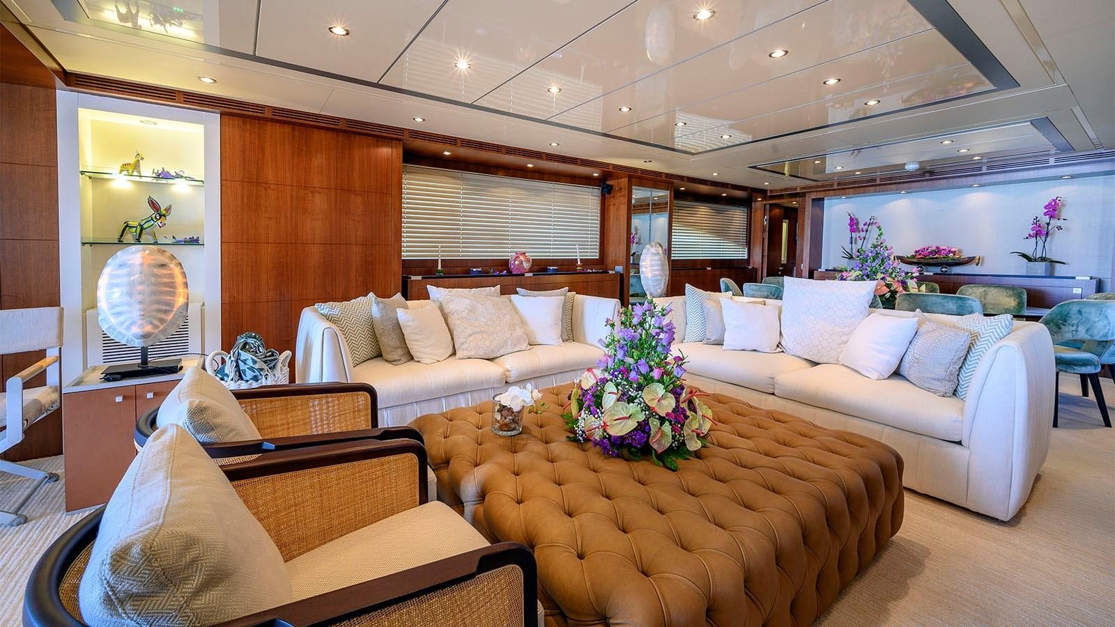 a living room with a couch and a table aboard BEYOND Yacht for Sale
