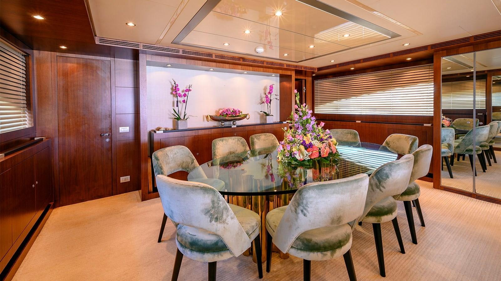 a room with a table and chairs aboard BEYOND Yacht for Sale