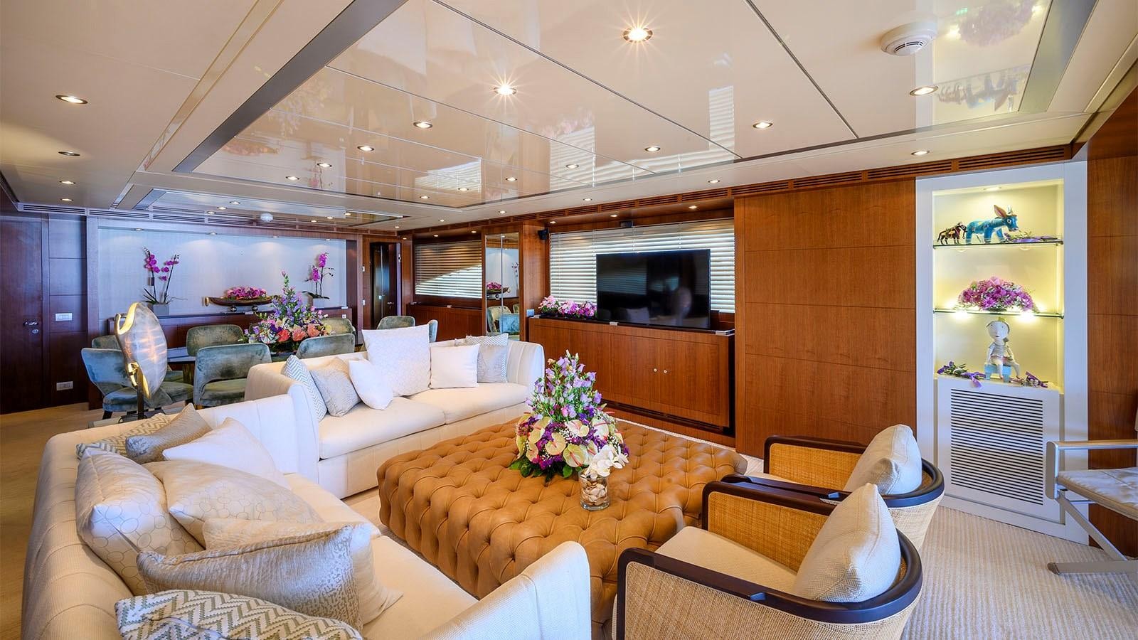 a living room with a large wood cabinet and a table aboard BEYOND Yacht for Sale