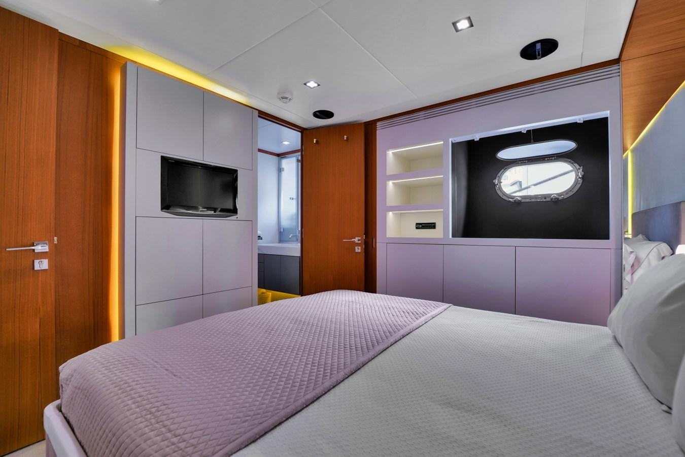 a bedroom with a bed and tv aboard DIAMOND Yacht for Sale
