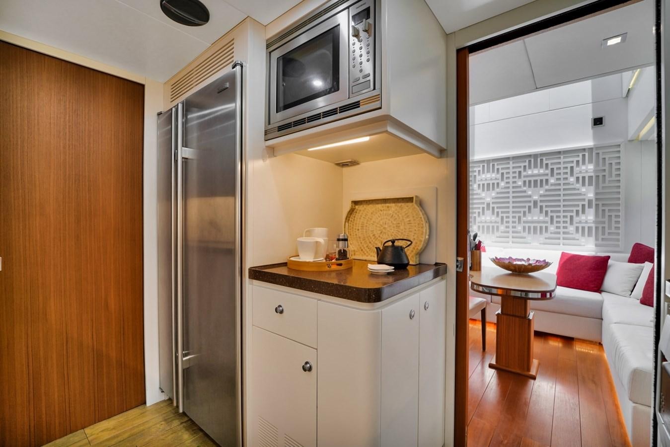 a kitchen with a microwave oven and a table aboard DIAMOND Yacht for Sale