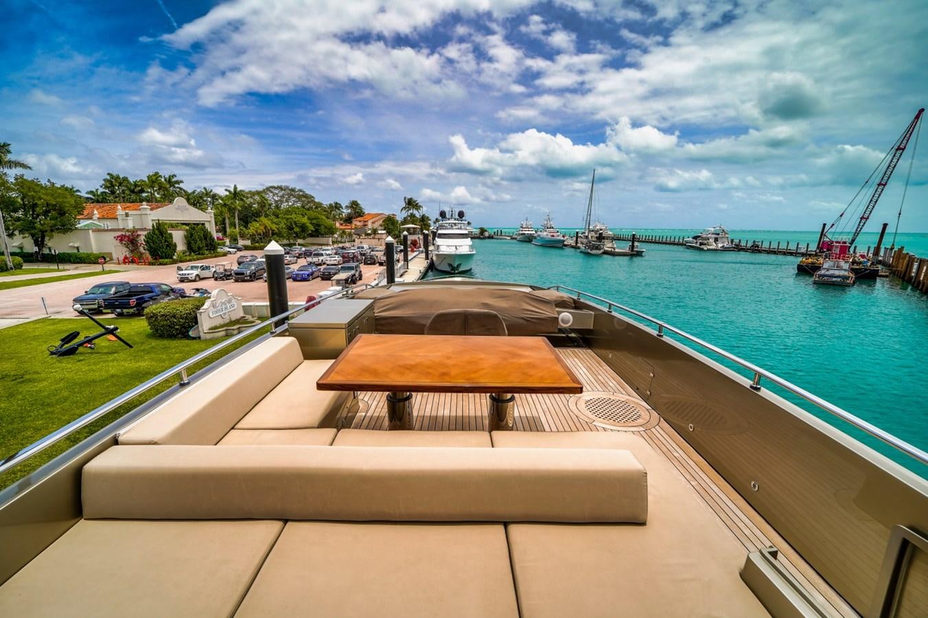 a deck with a pool and boats in the background aboard DIAMOND Yacht for Sale