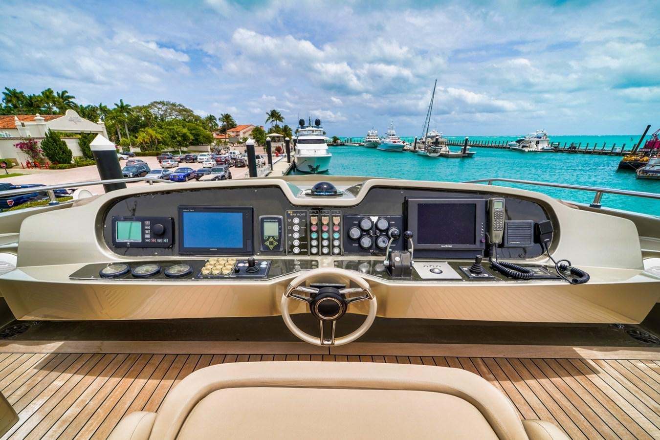 a view of a boat on the water with a steering wheel and boats in the background aboard DIAMOND Yacht for Sale