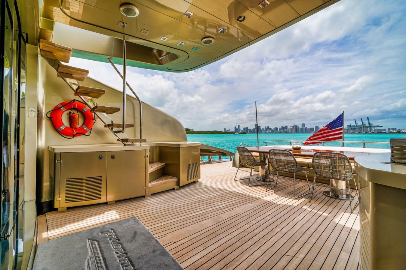 a deck with a flag and chairs on it aboard DIAMOND Yacht for Sale