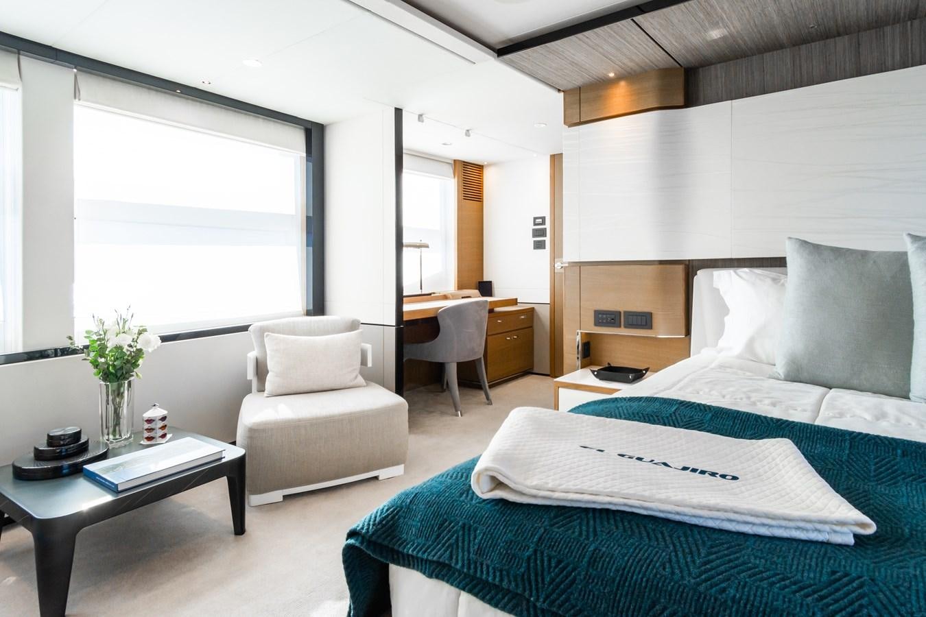 a bedroom with a bed and a coffee table aboard MINOR FAMILY AFFAIR Yacht for Sale