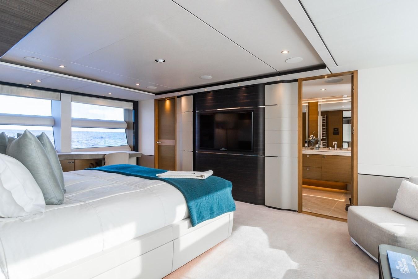 a bedroom with a bed and a television aboard MINOR FAMILY AFFAIR Yacht for Sale