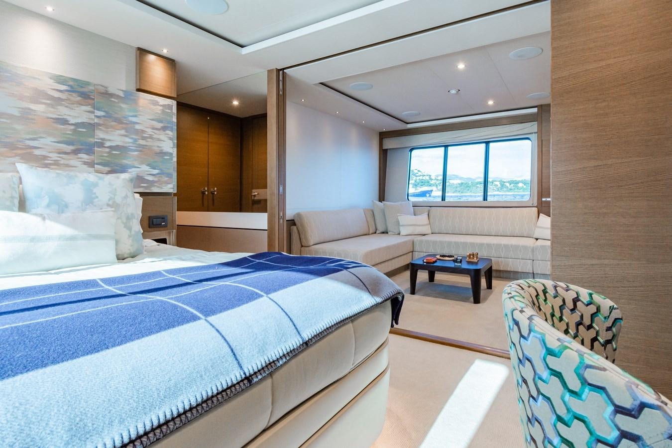 a bedroom with a bed and a table aboard MINOR FAMILY AFFAIR Yacht for Sale