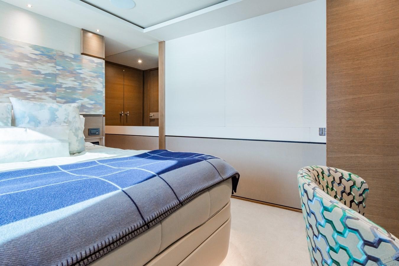 a bedroom with a blue bed aboard MINOR FAMILY AFFAIR Yacht for Sale