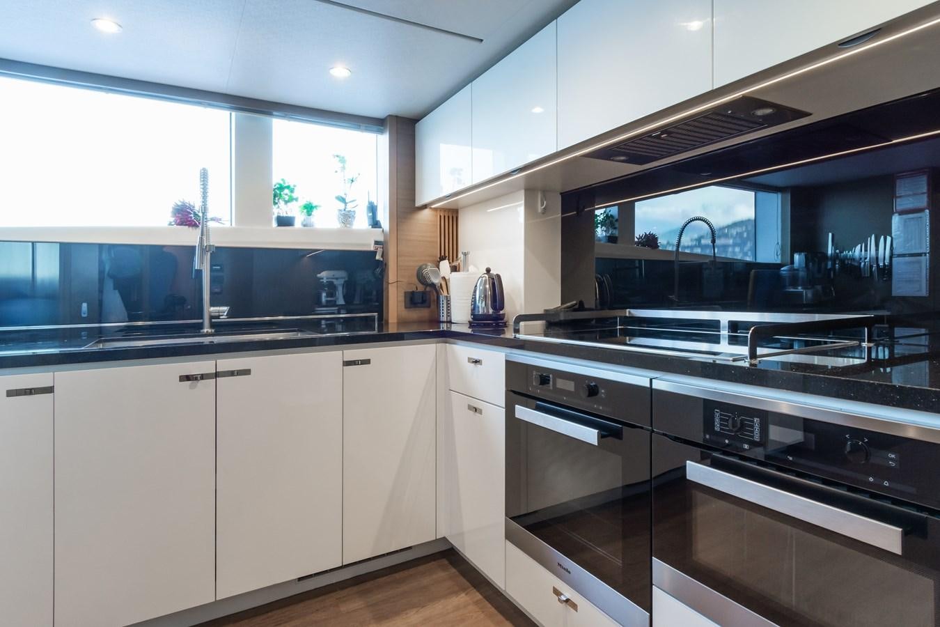 a kitchen with white cabinets aboard MINOR FAMILY AFFAIR Yacht for Sale