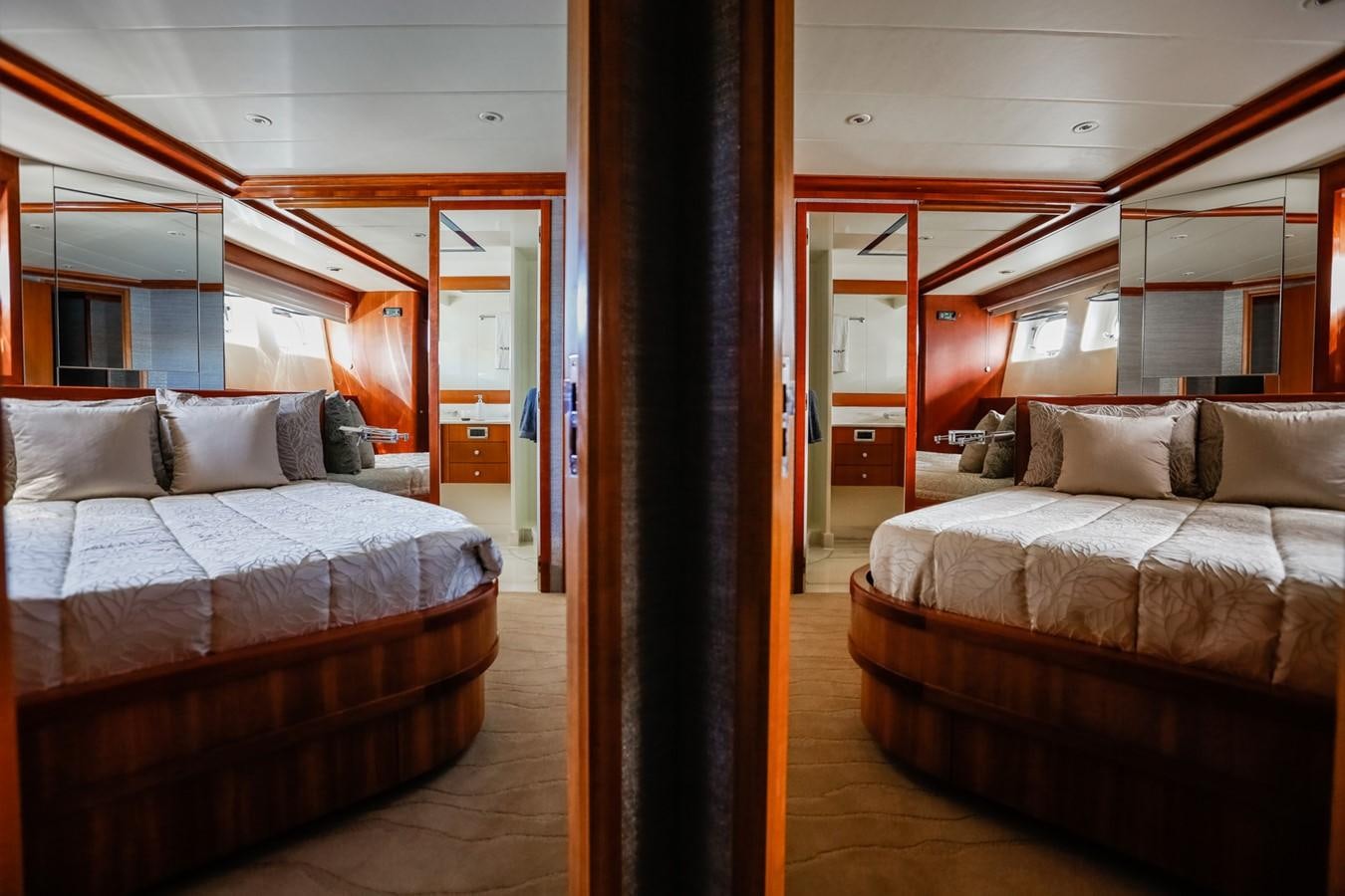 a room with a bed and a mirror aboard HUNTER Yacht for Sale