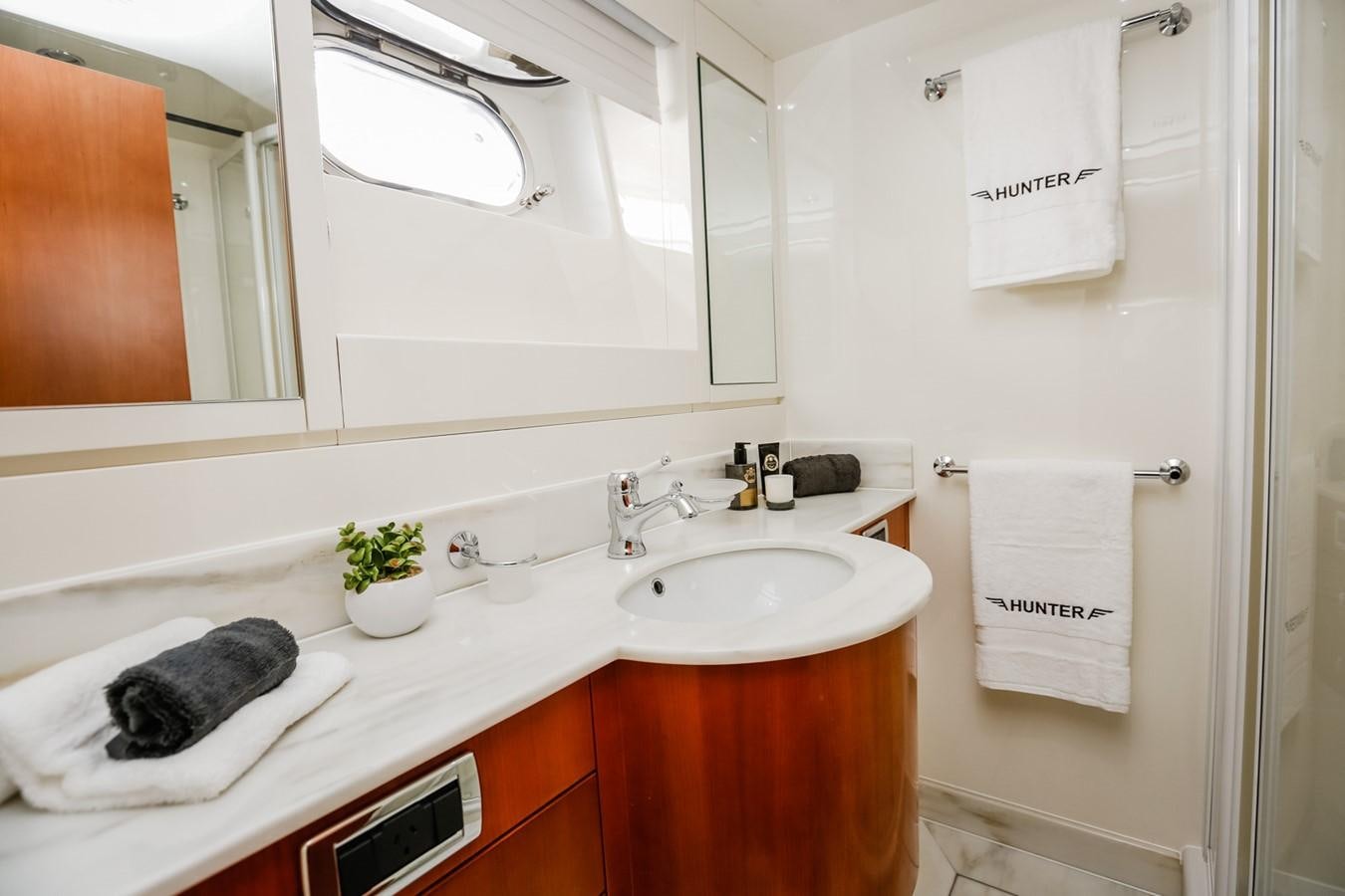 a bathroom with a sink and towels aboard HUNTER Yacht for Sale