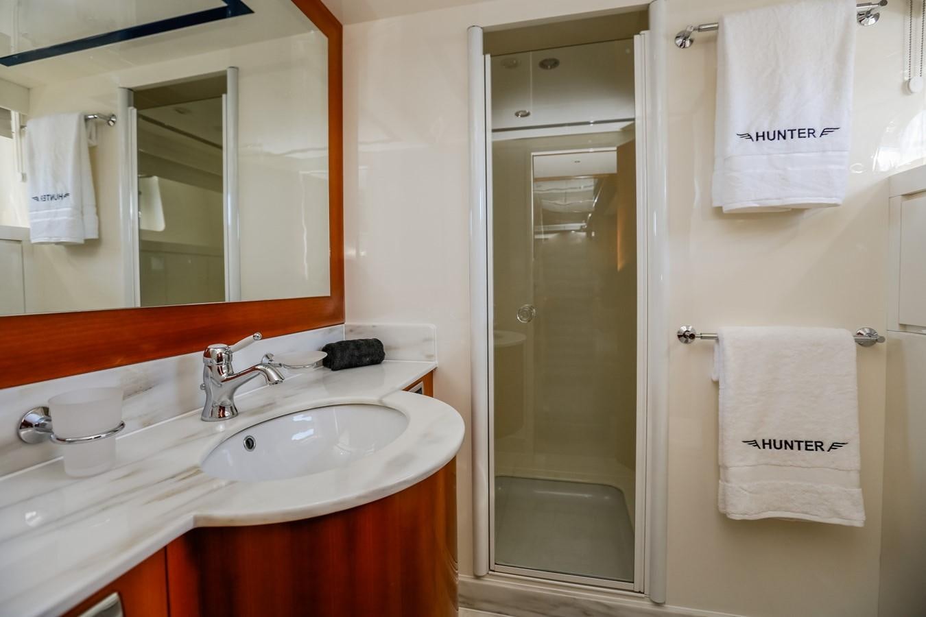a bathroom with a sink and a mirror aboard HUNTER Yacht for Sale