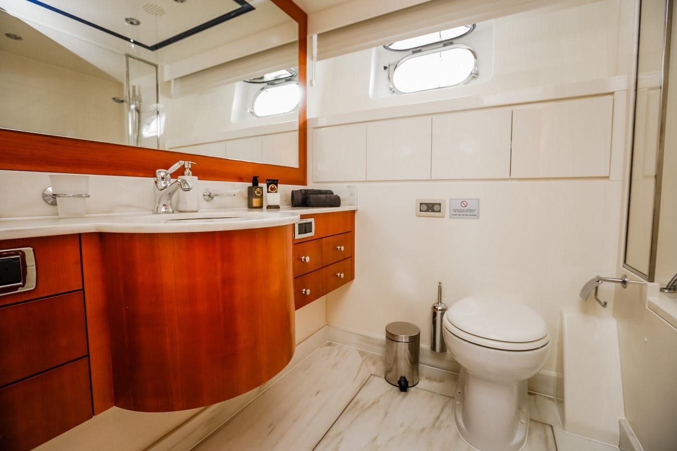 a bathroom with a toilet and a sink aboard HUNTER Yacht for Sale