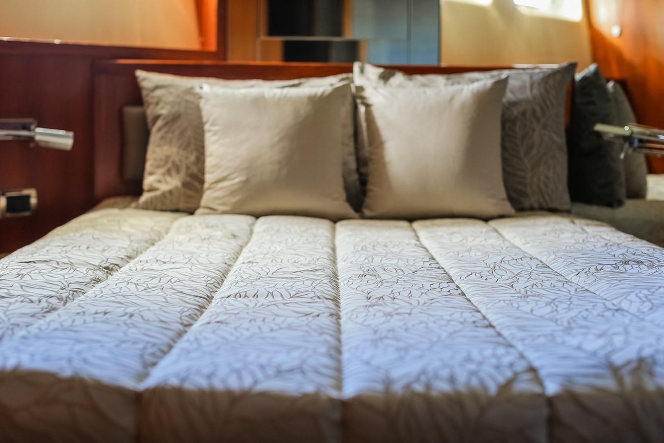 a bed with white sheets aboard HUNTER Yacht for Sale