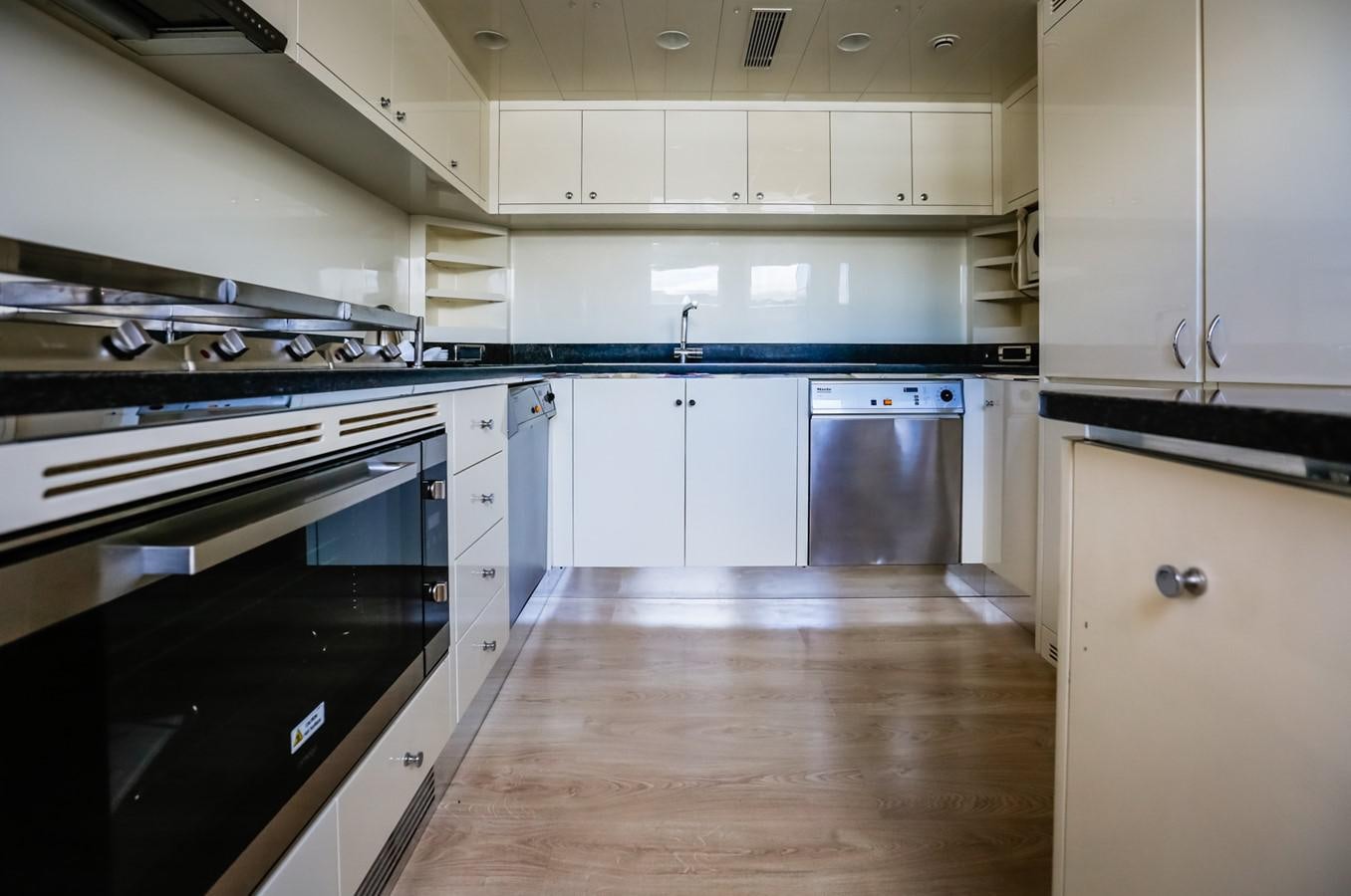 a kitchen with white cabinets aboard HUNTER Yacht for Sale