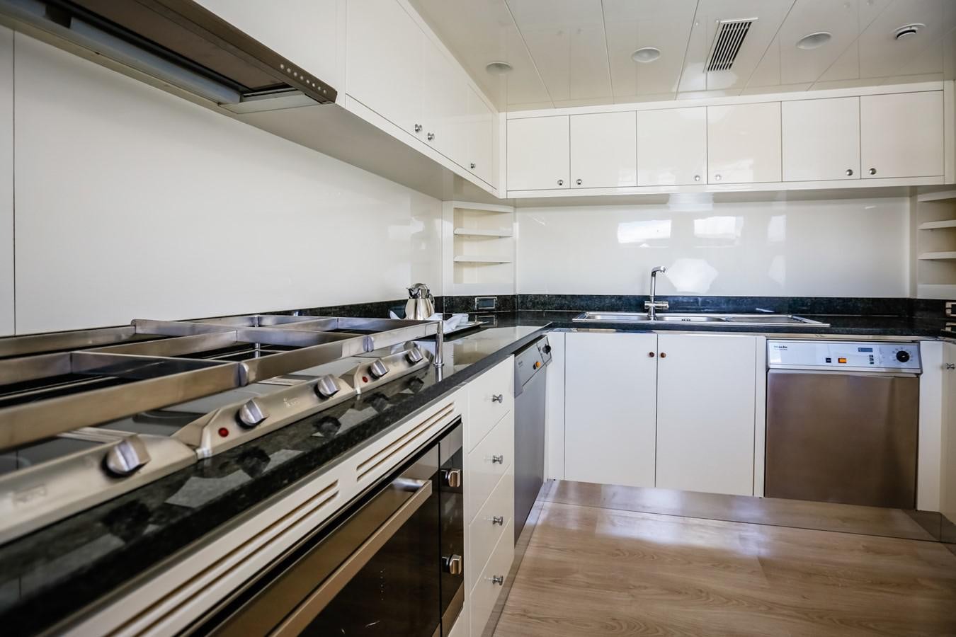 a kitchen with white cabinets aboard HUNTER Yacht for Sale