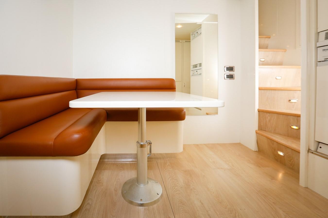 a kitchen with a table and a couch aboard HUNTER Yacht for Sale