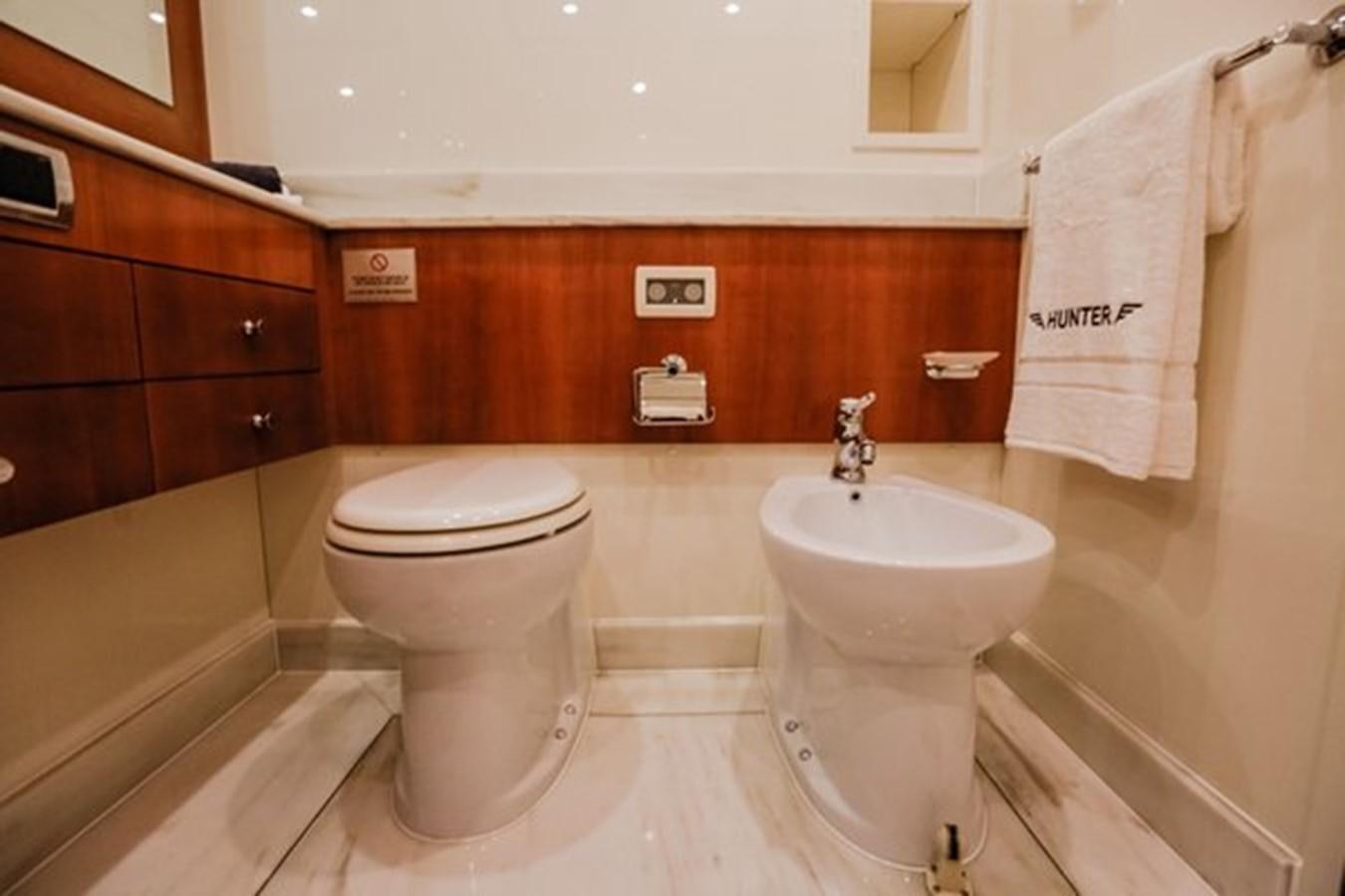 a bathroom with a toilet sink and a bathtub aboard HUNTER Yacht for Sale