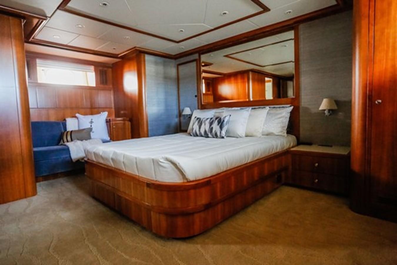 a bedroom with a bed and a mirror aboard HUNTER Yacht for Sale