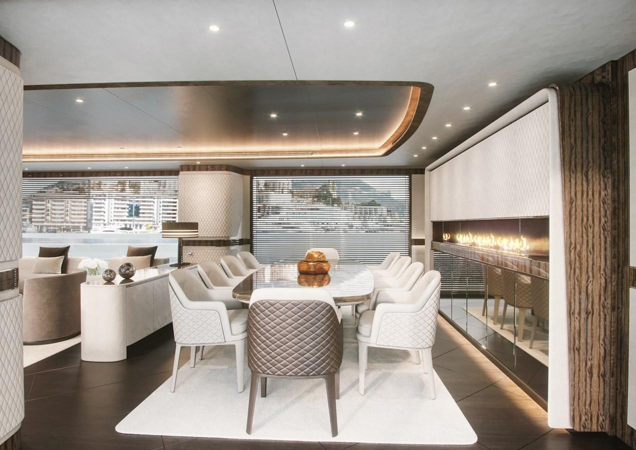 a room with a table chairs and a couch aboard DYNAMIQ GLOBAL 350 Yacht for Sale