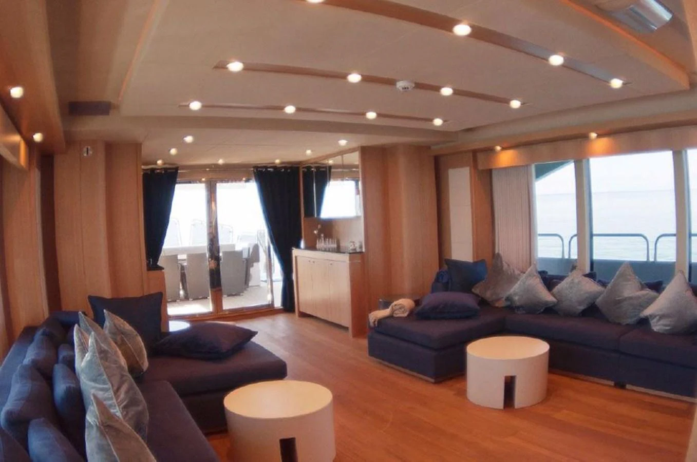 a living room with a couch and a large window aboard SUN FLOWER Yacht for Sale