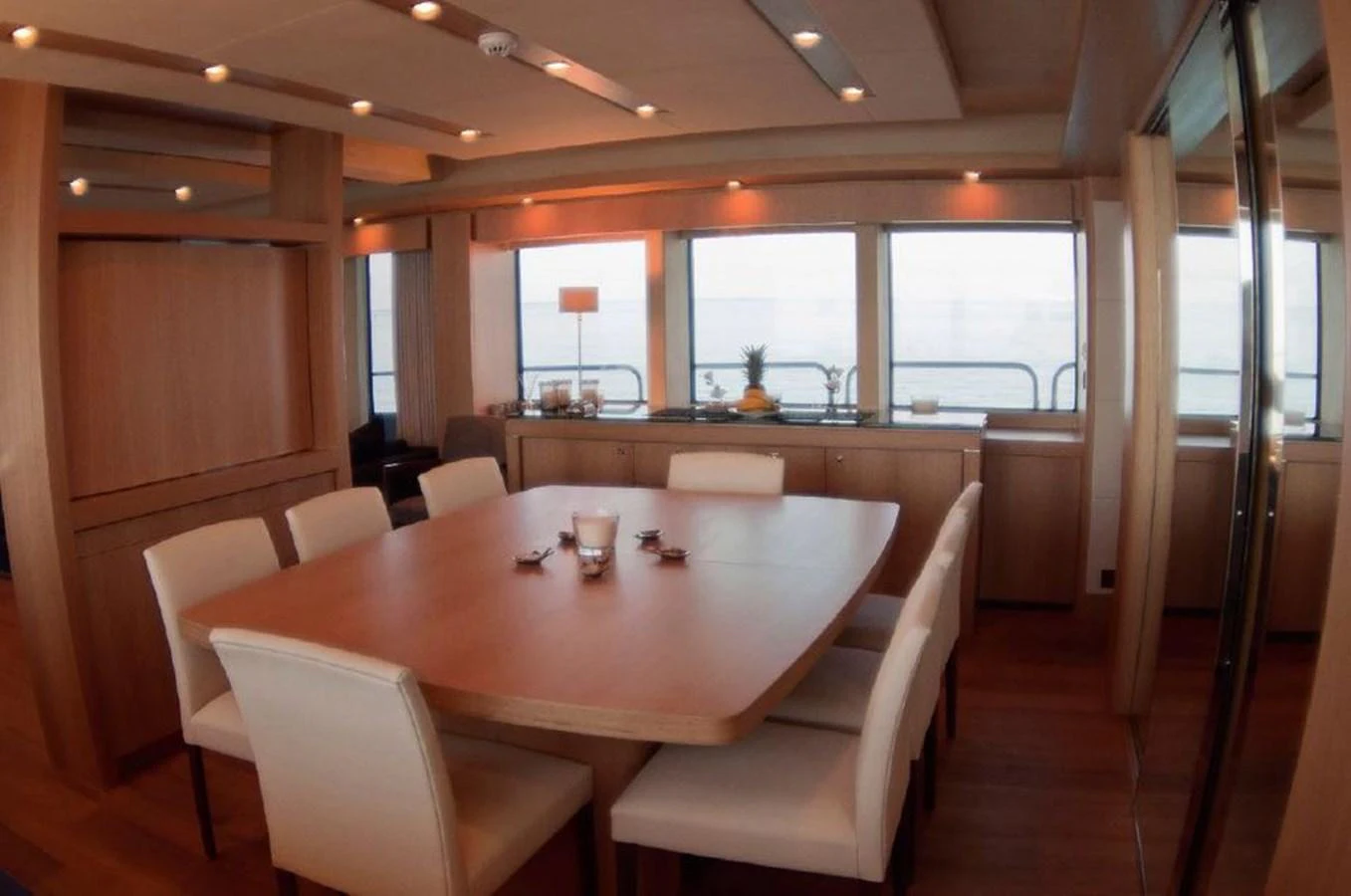 a table with chairs and a glass of wine on it aboard SUN FLOWER Yacht for Sale