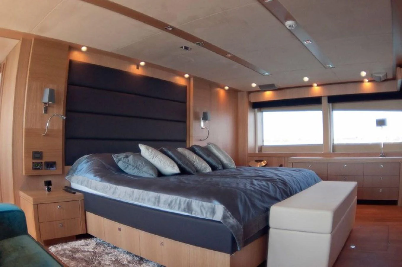 a bedroom with a bed and a dresser aboard SUN FLOWER Yacht for Sale