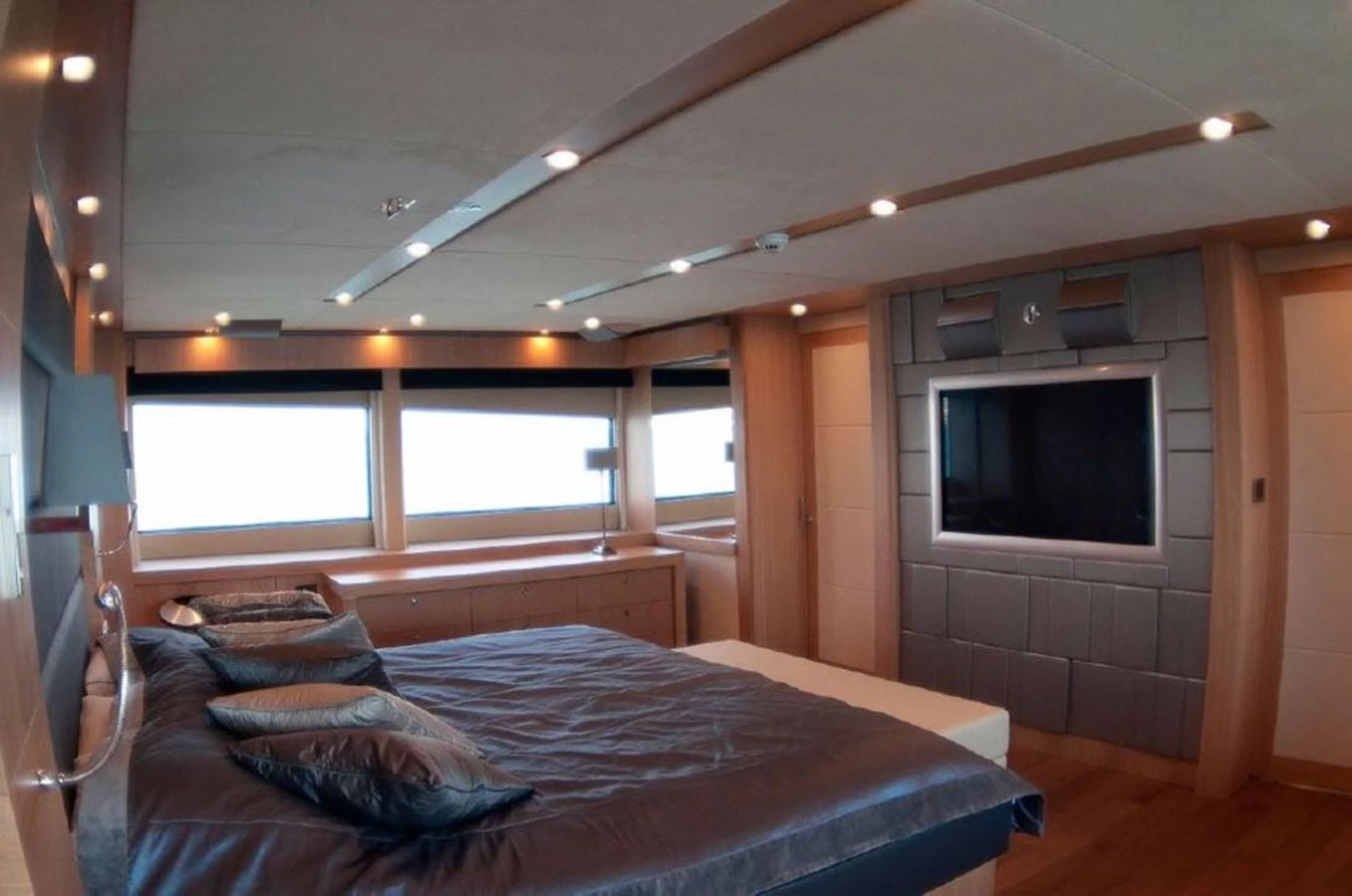 a bedroom with a bed and a tv aboard SUN FLOWER Yacht for Sale
