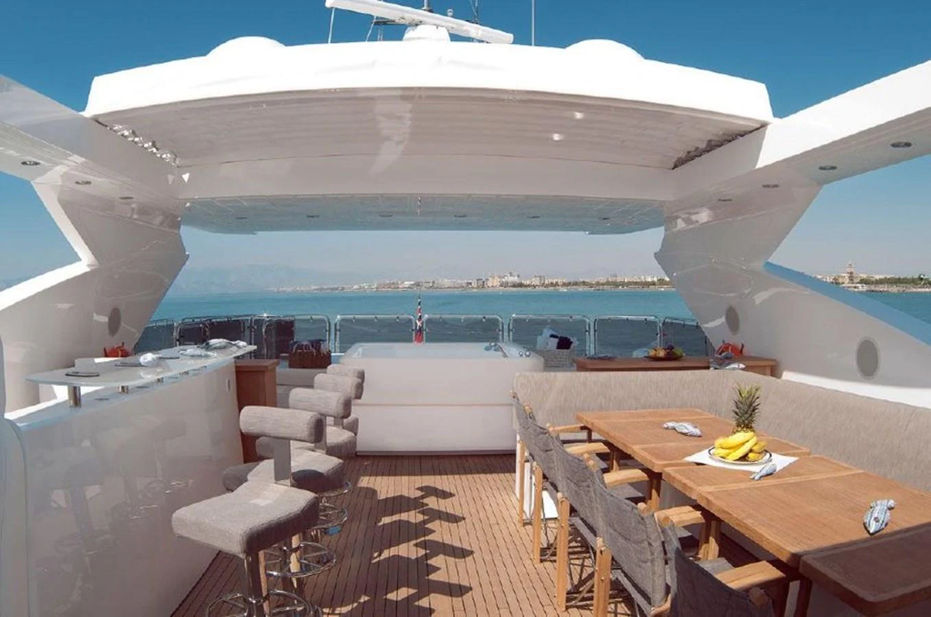 a room with a table and chairs and a view of the water aboard SUN FLOWER Yacht for Sale