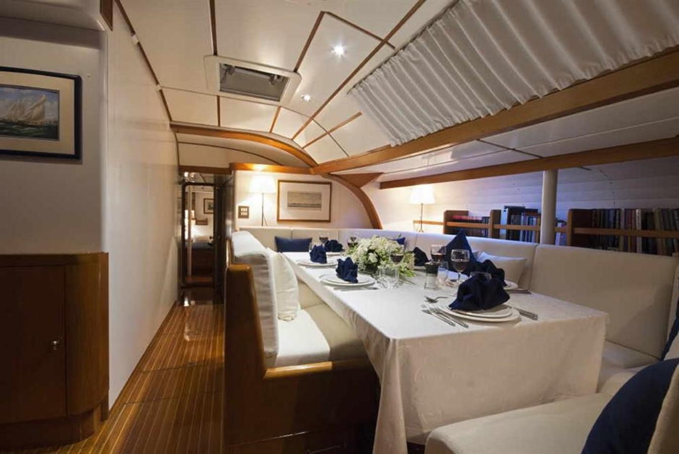 a room with tables and chairs aboard BAIURDO VI Yacht for Sale