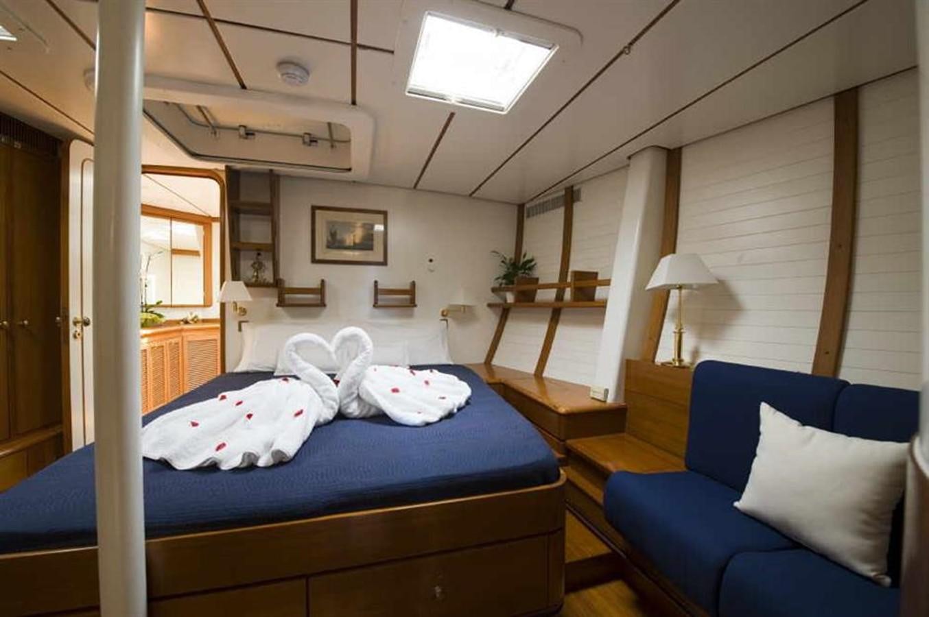 a room with a bed and a chair aboard BAIURDO VI Yacht for Sale