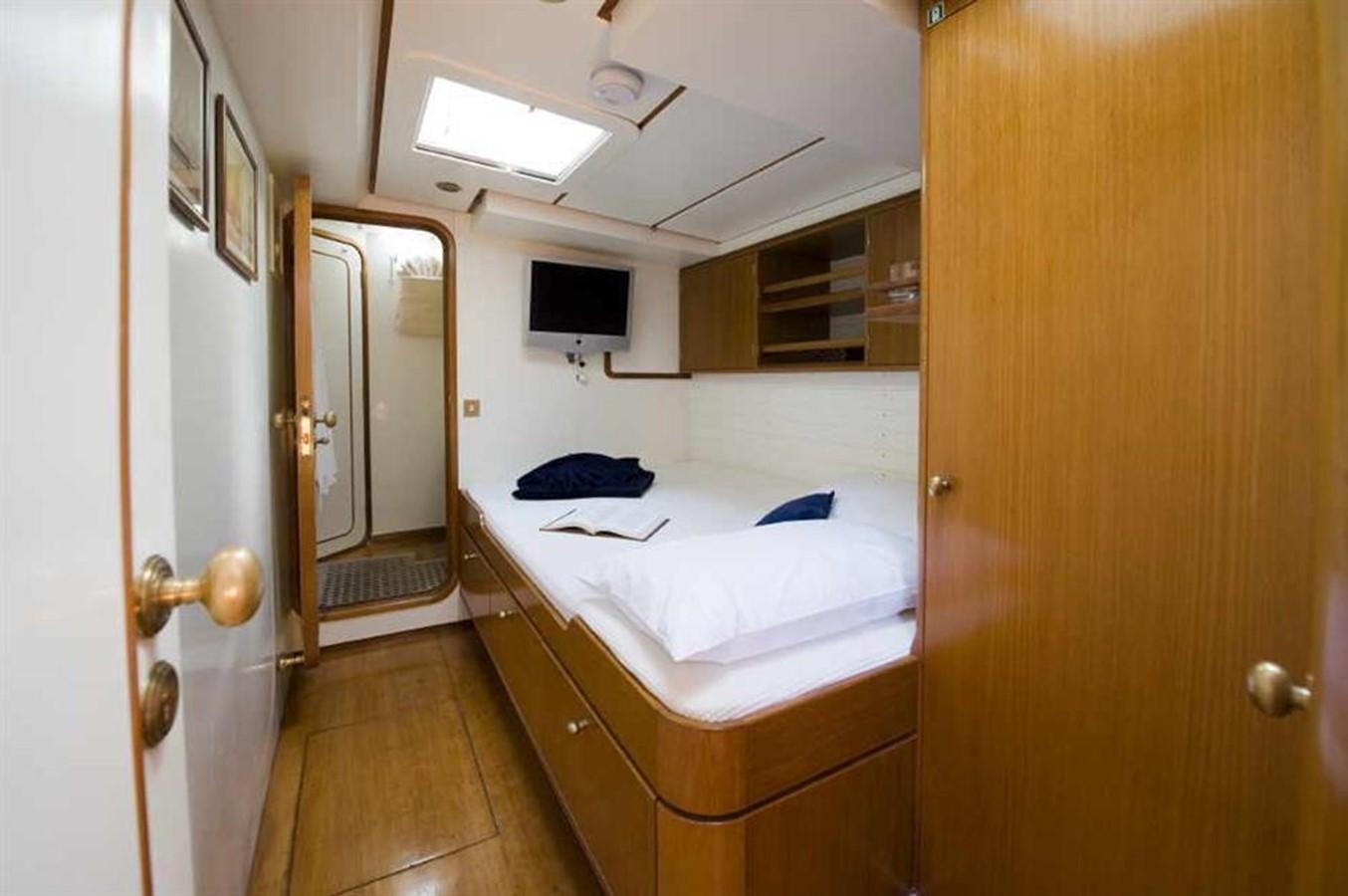 a room with a bed and a television aboard BAIURDO VI Yacht for Sale