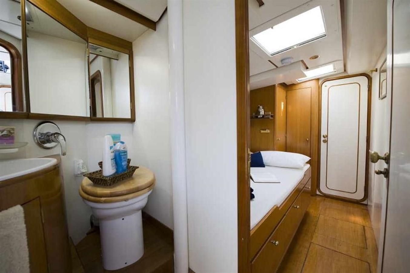 a bathroom with a sink toilet and a mirror aboard BAIURDO VI Yacht for Sale