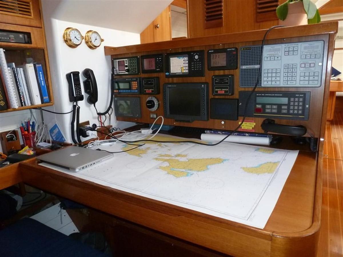 a desk with computers and telephones aboard BAIURDO VI Yacht for Sale
