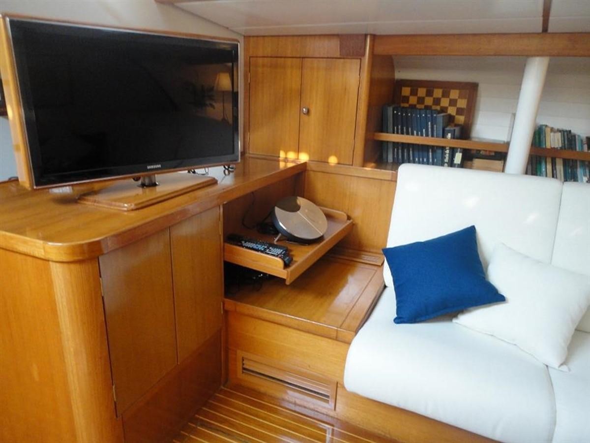 a living room with a tv and a couch aboard BAIURDO VI Yacht for Sale
