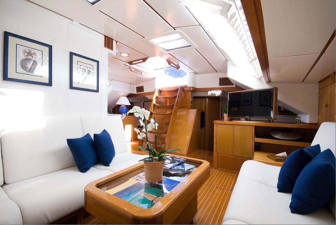 a living room with a white couch and a television aboard BAIURDO VI Yacht for Sale